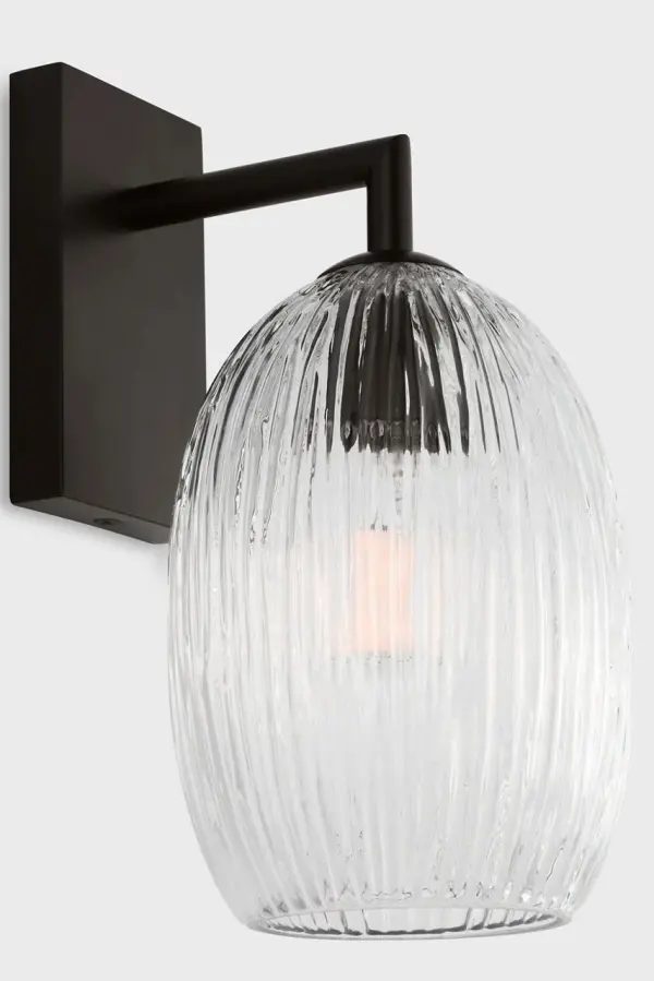 The Serafina 10" Sconce transforms walls with its soft, organic silhouette inspired by dried ceramics. Featuring distinctive combed glass texture that reflects Hable's artisanal heritage, it casts gentle ambient light perfect for intimate spaces. - alternate view