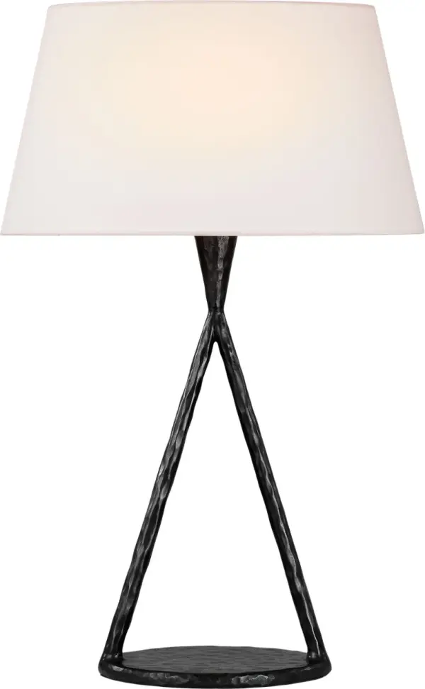 The Cesta table lamp combines artistic metalwork with functional lighting. At 28" tall, this substantial piece features a sculpted aged iron base paired with a classic linen shade, creating sophisticated ambiance in any space.