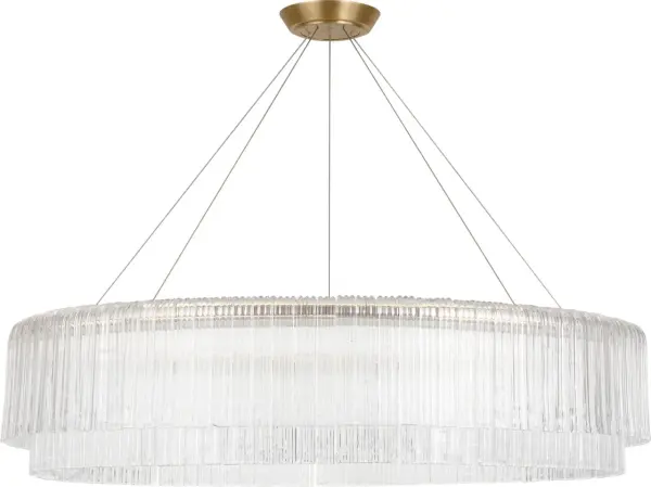 The Maderno 48" chandelier makes a bold statement with its substantial scale and hand-rubbed antique brass finish. Clear glass shades provide brilliant illumination while the linear design suits both traditional and contemporary spaces.