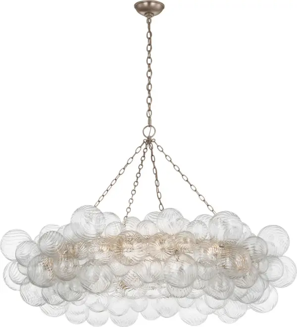 The Talia 54" Ring Chandelier by Julie Neill combines whimsical artisanal glass orbs with refined metalwork for a statement piece that adds feminine elegance and sparkling light to grand spaces.