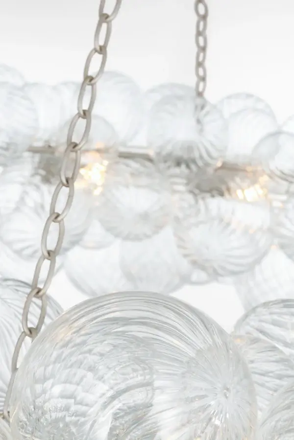 The Talia 63" Ring Chandelier by Julie Neill transforms grand spaces with its whimsical arrangement of swirled glass orbs in metal baskets. The burnished silver leaf finish adds sophisticated sparkle while the artisanal glass creates dynamic light play. - alternate view