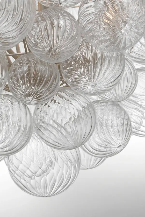 The Talia chandelier by Julie Neill combines artisanal swirled glass orbs with burnished silver leaf metalwork for a sophisticated yet playful statement piece. At 46 inches, it's perfectly scaled for larger dining rooms and entryways. - alternate view