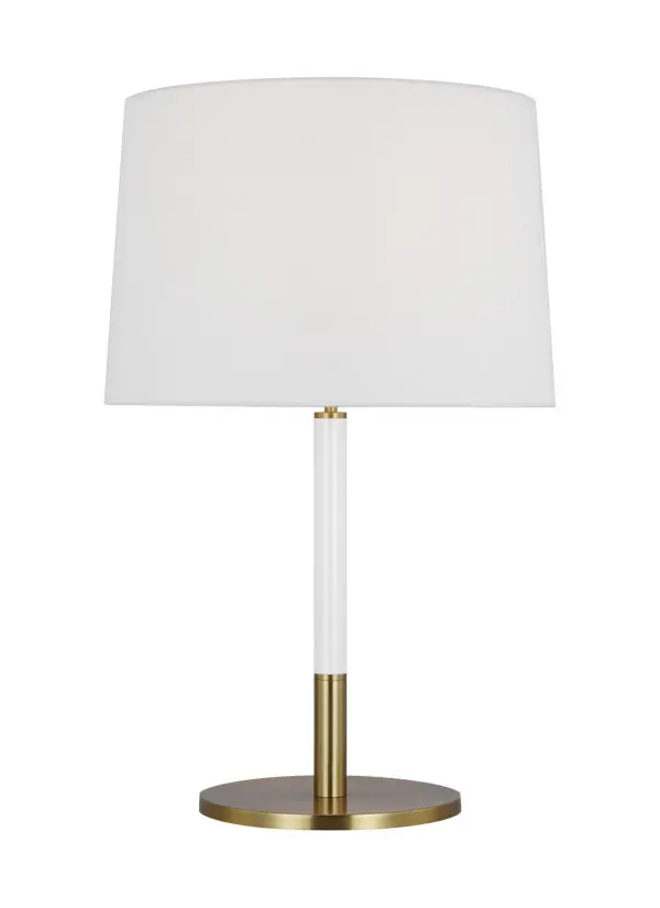 The Monroe table lamp brings 1950s atomic era design into modern spaces with its graphic enameled metal construction and burnished brass finish. The white linen shade softens the bold metallic base, creating versatile ambient lighting.