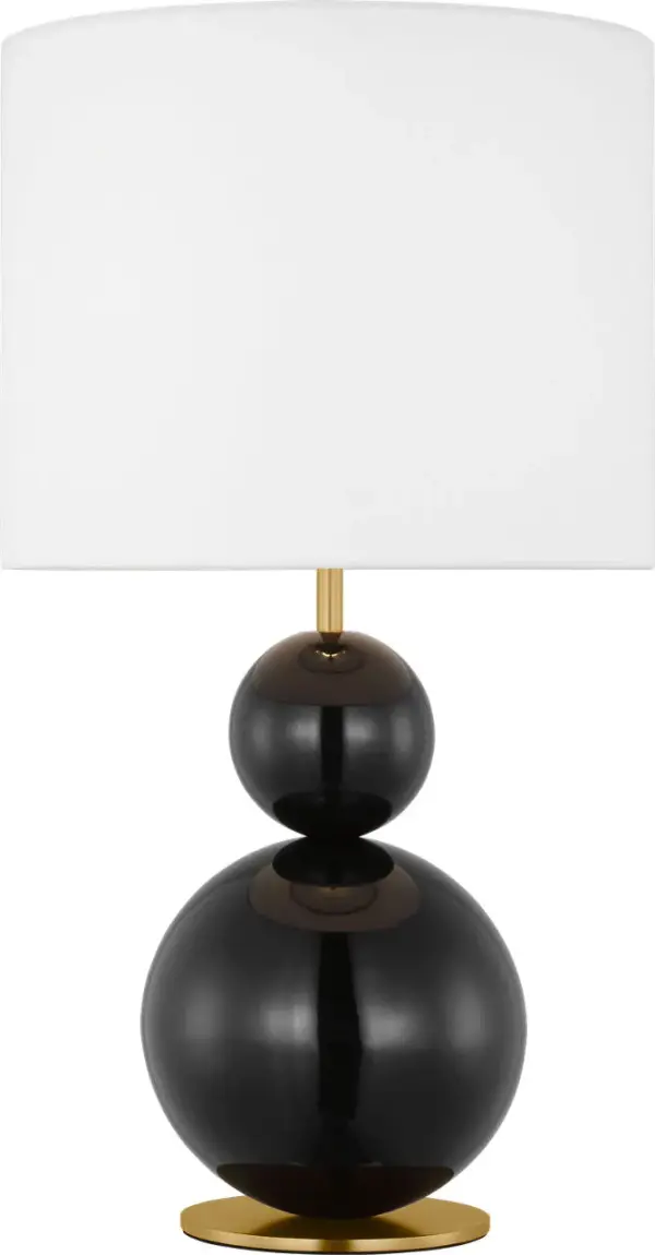 The Suki Medium Table Lamp transforms minimalist design with its stacked geometric metal forms and striking gloss black finish. The white linen drum shade softly diffuses light while the sculptural silhouette creates an artistic statement piece.