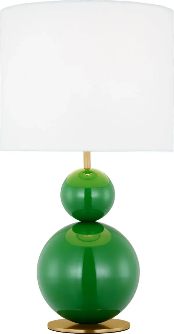 The Suki Medium Table Lamp by kate spade new york transforms minimalist design with its elegant stacked geometric forms and striking green finish. The sculptural metal base paired with a white linen drum shade creates a statement piece that brings artistic flair and warmth to any space.