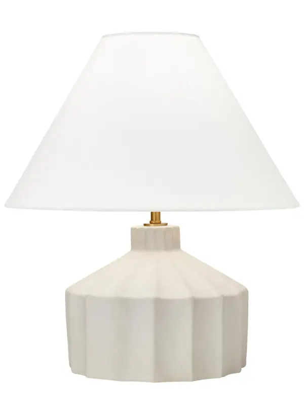 This Kelly Wearstler-designed table lamp transforms authentic concrete into a sophisticated lighting sculpture. The uneven texture and matte finish create an artisanal modern aesthetic, while the white linen shade softens the industrial material.