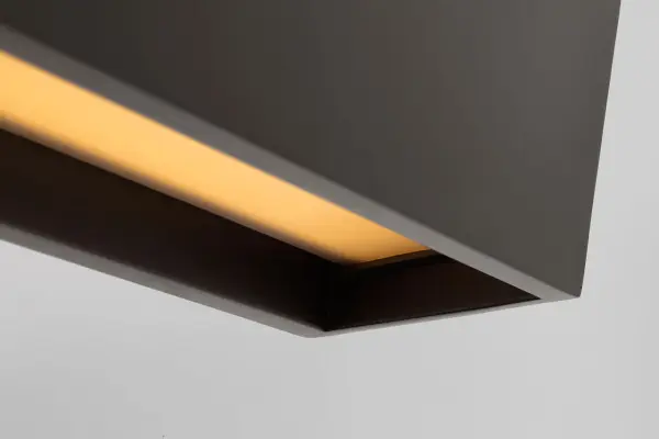 The Pench Large Linear Chandelier delivers contemporary elegance with its tapered silhouette and Dark Bronze finish. High-quality 2700K LED provides warm, inviting light with exceptional 90 CRI color rendering for dining and entertaining spaces. - alternate view