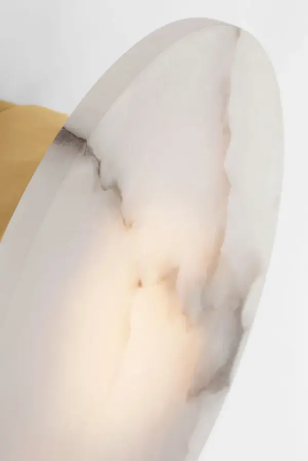 Kelly Wearstler's Melange sconce combines carved natural alabaster with antique-burnished brass for a sophisticated, organic modern aesthetic. The unique alabaster veining creates soft, ambient lighting while the rounded forms add sculptural interest to walls. - alternate view