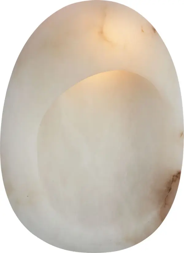 The Esculpa wall light combines organic alabaster with warm antique brass for a sophisticated statement piece. Its 14-inch rounded form creates ambient lighting while serving as functional art for refined interiors.