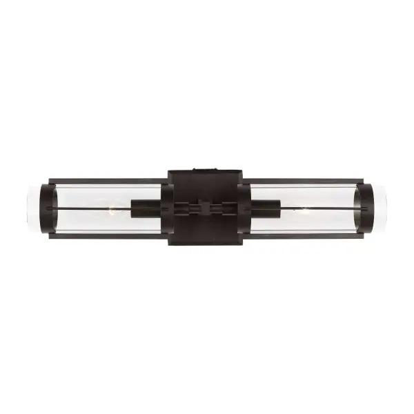 The Flynn vanity light delivers authentic mid-century design with geometric vertical tubes and sleek straight arms. Its compact 20-inch width and Aged Iron finish bring sophisticated style to smaller bathrooms without overwhelming the space.