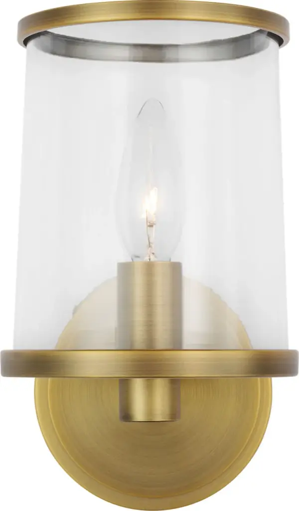 The Reynolds Small Vanity combines industrial minimalism with vintage elegance through its clear glass shade and Time Worn Brass finish. Perfect for bathrooms and powder rooms, it delivers soft ambient lighting with character.