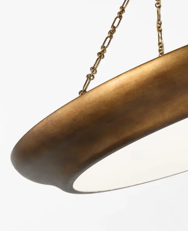 The Lenoir 36" Chandelier commands attention with its inverted bowl silhouette and striking contrast between matte aged iron exterior and luminous gilded interior. Inspired by 1930s French design, it delivers architectural presence perfect for grand dining rooms and open living spaces. - alternate view