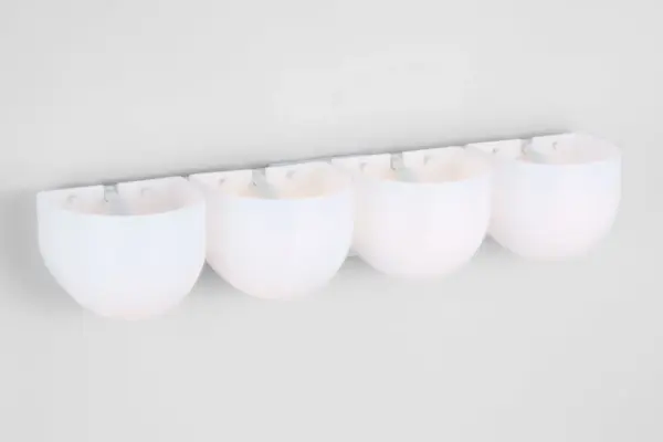 The Cheverny Extra Large Vanity by Christiane Lemieux features four rounded milk glass shades that provide ample illumination for larger bathrooms. Its minimalist matte white backplate creates a refined, contemporary aesthetic. - alternate view