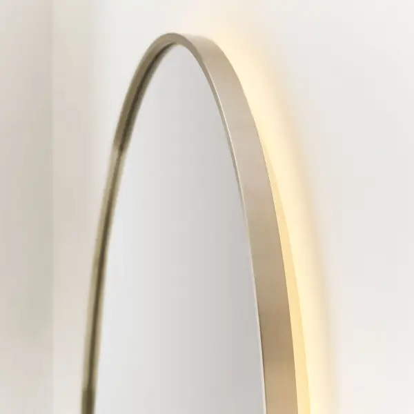 The Cadre round mirror combines elegant design with practical functionality. Its warm backlit LED glow creates ambiance while on-mirror touch controls allow dimming and color temperature adjustment from task to mood lighting. - alternate view