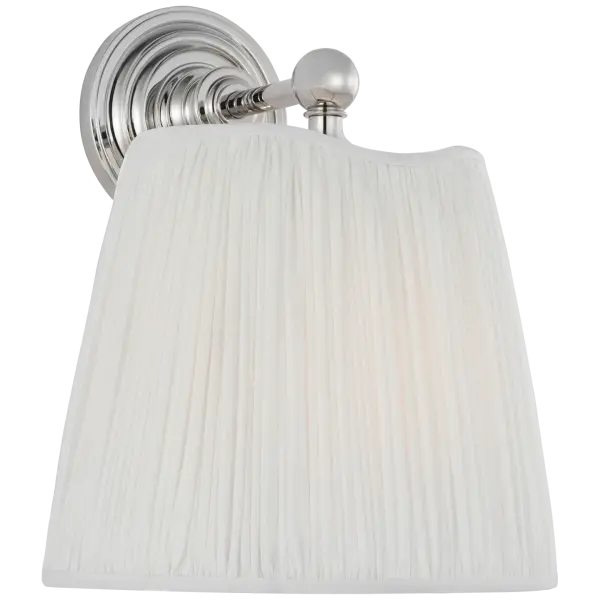 The Matos sconce combines polished nickel hardware with a sophisticated silk pleat shade, delivering refined ambient lighting. Its 11-inch profile makes it ideal for flanking mirrors or creating symmetrical wall displays.