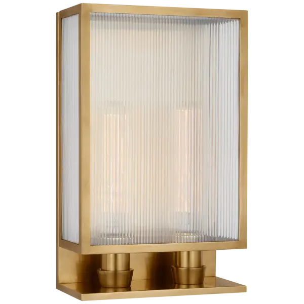 The York 16" Double Box Sconce combines classic brass warmth with contemporary ribbed glass detailing. Its generous 16-inch width provides substantial illumination while the soft brass finish adds sophisticated elegance to any space.