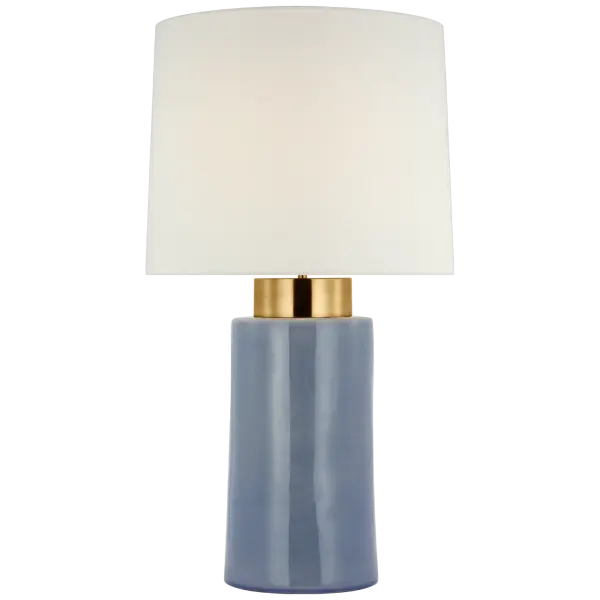 The Xian 30" table lamp combines artisanal crackle ceramic in polar blue with soft brass accents, creating a sophisticated transitional piece. The linen shade provides warm, diffused light perfect for living spaces.