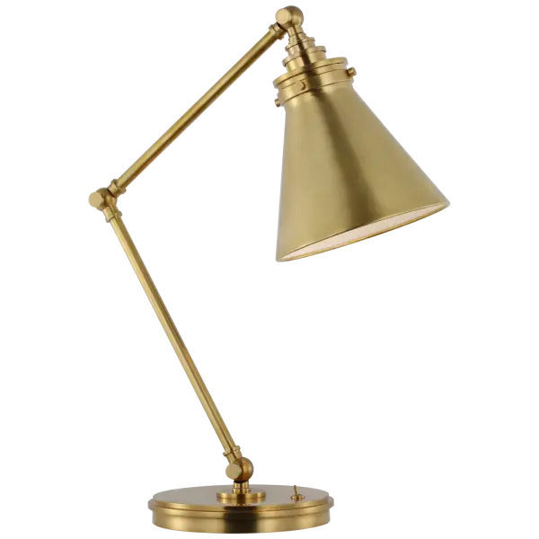 The Parkington desk lamp combines functional articulation with timeless brass styling. Its adjustable arm provides directed task lighting while the antique-burnished finish adds warmth to any workspace.