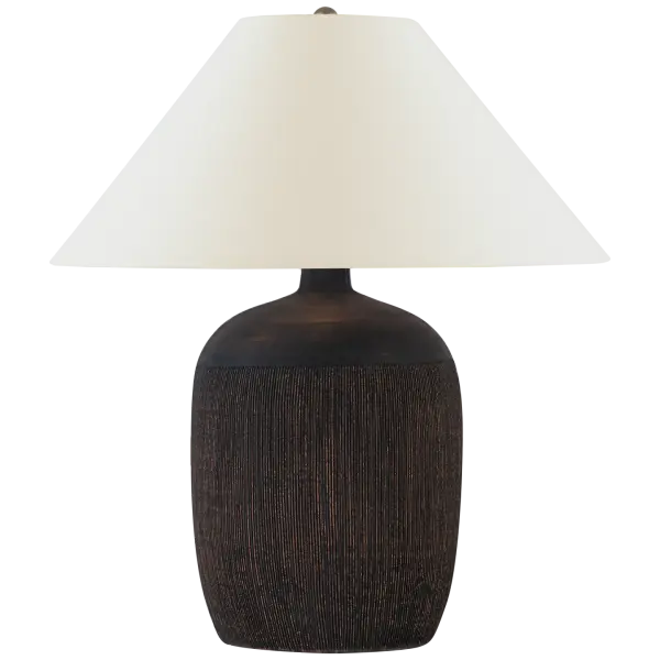 The Portis 32" table lamp features a distinctive combed round terracotta base with black wash finish, creating rich texture and visual interest. The natural linen shade softens the light while complementing the earthy base.
