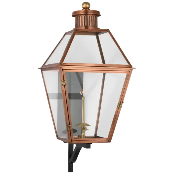 The Stratford Large Bracketed Gas Wall Lantern combines traditional craftsmanship with durable outdoor construction. Its soft copper finish and clear glass panels create warm, inviting illumination for grand entrances and outdoor living spaces.