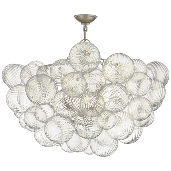 The Talia brings sophisticated transitional style with its burnished silver leaf finish and clear swirled glass. At 33" wide, this semi-flush mount makes a statement in larger spaces while maintaining a refined, elegant presence.