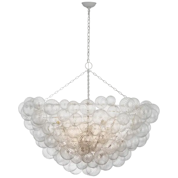 The Talia 56" chandelier makes a dramatic statement with its generous scale and organic swirled glass shades. The plaster white finish provides a soft, sophisticated backdrop for the clear glass elements, creating visual interest and ambient lighting.