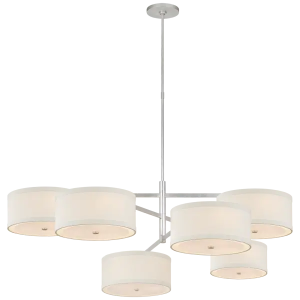 The Walker Grande Offset Chandelier brings architectural interest with its asymmetrical design and refined burnished silver leaf finish. Linen shades provide soft, diffused light perfect for dining and entertaining spaces.
