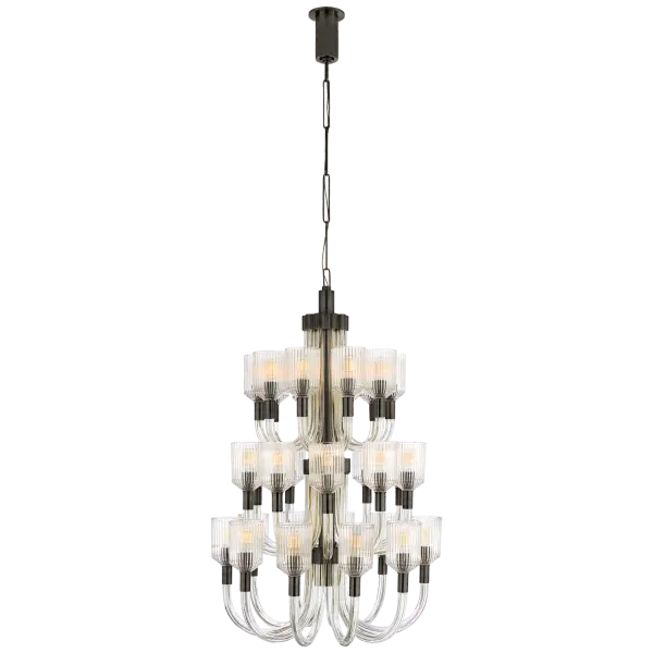 The Reverie Large Chandelier commands attention with its dramatic three-tier design and clear ribbed glass shades. Bronze finish adds warmth while the textured glass creates beautiful light diffusion for grand spaces.