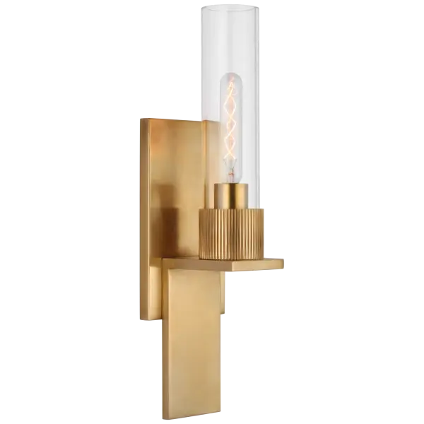 The Beza Small Bath Sconce combines classic styling with contemporary sensibility. Its antique brass finish and clear glass shade create warm, inviting illumination perfect for bathrooms and intimate spaces. - alternate view