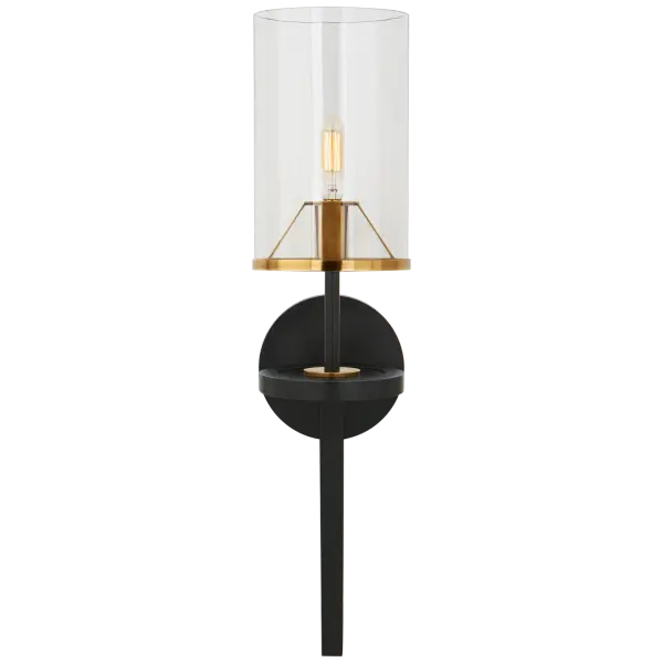 The Vivier Single Sconce combines blackened iron with hand-rubbed antique brass for a sophisticated two-tone finish. Its clear glass cylinder shade provides clean, unobstructed light perfect for bathrooms and hallways.