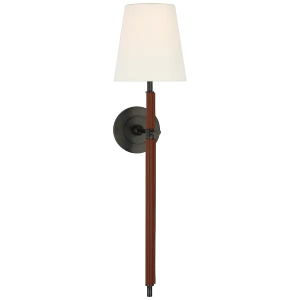 The Bryant Large Sconce combines refined bronze metalwork with luxurious saddle leather wrapping and a soft linen shade. This distinctive fixture adds warmth and texture to any space while providing elegant ambient lighting.