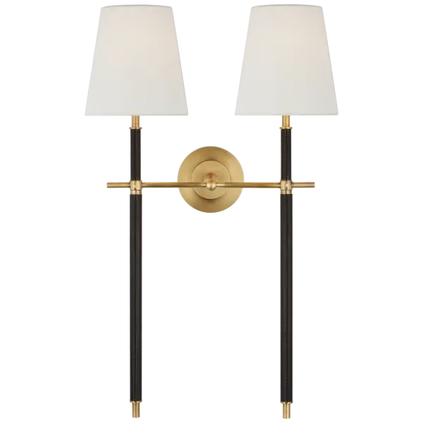 The Bryant Large Sconce combines warm antique brass with rich chocolate leather wrapping, creating a refined statement piece. Its double-tail design with linen shades provides balanced ambient lighting perfect for traditional and transitional interiors.