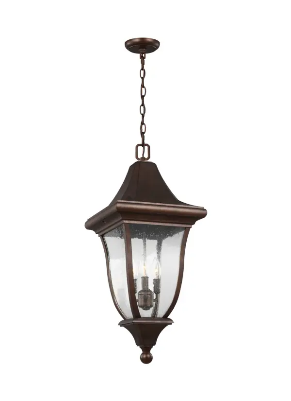 The Oakmont pendant brings architectural elegance outdoors with its steeply pitched roofline, curved seeded glass panels, and cast aluminum durability. The Patina Bronze finish adds timeless character to covered entries and porches.