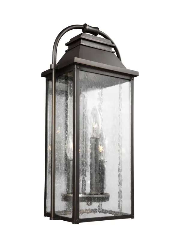 The Wellsworth lantern by Sean Lavin blends traditional design with subtle nautical influences. Cast aluminum construction and Wet Rating ensure long-lasting outdoor performance, while seeded glass adds vintage character.