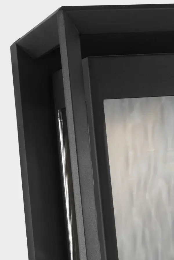 The Urbandale Grande Wall Lantern combines substantial scale with refined transitional styling. Its textured black finish and clear glass panels create dramatic curb appeal while providing excellent illumination for larger outdoor spaces. - alternate view