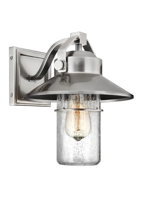The Boynton outdoor lantern by Sean Lavin combines industrial and nautical design elements with exceptional durability. Its StoneStrong construction offers superior weather resistance with a 5-year warranty, while the shepherd's crook arm and handle details add authentic character.