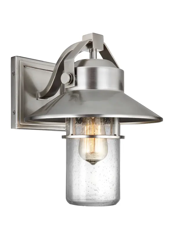 The Boynton outdoor lantern by Sean Lavin combines industrial and nautical design elements with exceptional durability. Its StoneStrong construction offers superior weather resistance with a 5-year warranty, while the shepherd's crook arm and handle details add authentic character.