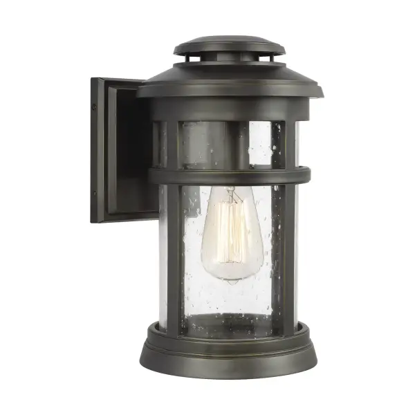The Newport wall lantern combines nautical charm with practical durability. Its StoneStrong construction withstands harsh coastal conditions while the lighthouse-inspired vented top and detailed cast frame add authentic character.