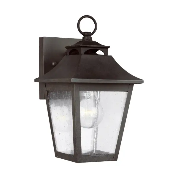The Galena wall lantern brings timeless European elegance to outdoor spaces with its gently curved hook detail, vented roofline, and floating candle tube design. The Sable finish adds warmth while clear glass maximizes light output.
