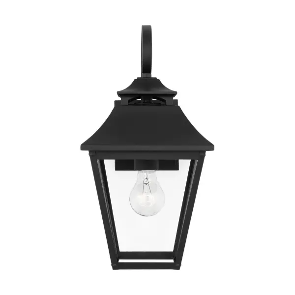 The Galena outdoor wall sconce brings timeless elegance to exterior spaces with its gently curved hook detail, vented roofline, and floating candle tube design. Wet-rated for durability and safety.