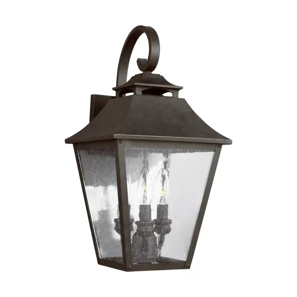 The Galena outdoor lantern by Sean Lavin brings timeless European elegance to exterior spaces. Its refined silhouette features a curved hook detail, vented roofline, and floating candle tubes within tapered clear glass.
