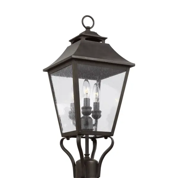 The Galena post lantern brings timeless elegance to outdoor spaces with its gently curved hook detail, vented square roofline, and floating candle tubes within tapered clear glass. The warm Sable finish adds sophistication.
