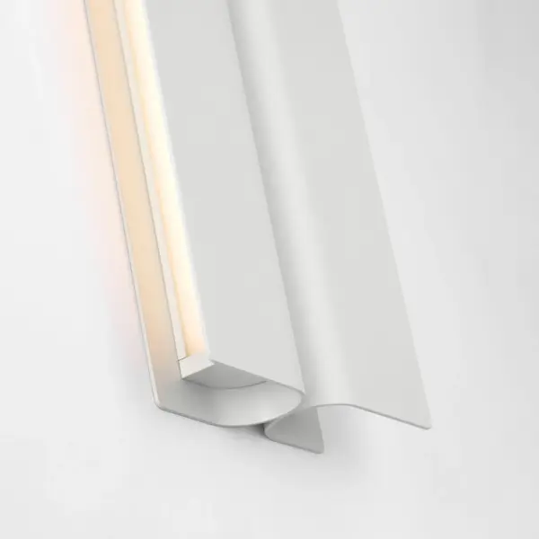 The Cloak 18" Vanity by Peter Bristol transforms functional lighting into architectural art. Its folded metal forms conceal the light source while directing illumination with precision, eliminating glare in compact spaces. - alternate view