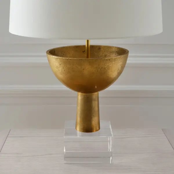 The Eadan table lamp combines museum-quality brass craftsmanship with a classic linen shade, creating sophisticated ambient lighting. At 26 inches, it provides substantial presence without overwhelming spaces.