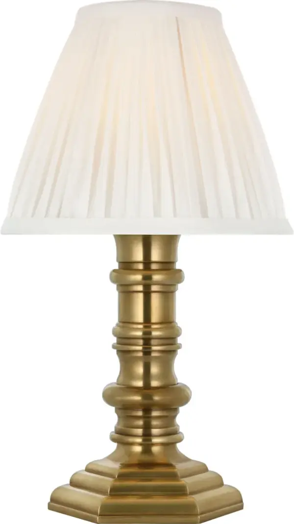 The Thatcher cordless accent lamp combines sophisticated natural brass metalwork with a refined silk pleated shade. Its portable, battery-powered design offers placement flexibility without sacrificing style.