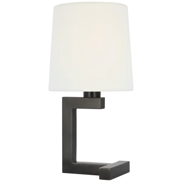 The Hedger 12" Accent Lamp combines timeless bronze metalwork with a soft linen shade, creating warm ambient lighting perfect for intimate spaces. Its compact 12" size makes it ideal for bedside tables and desks.