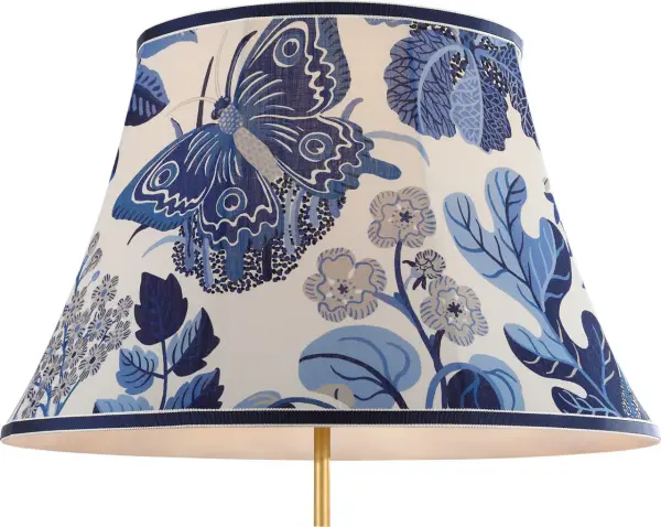 This Schumacher collaboration brings sophisticated coastal elegance with a vibrant marine butterfly motif. The 20" soft empire silhouette offers versatile styling for both traditional and contemporary interiors.