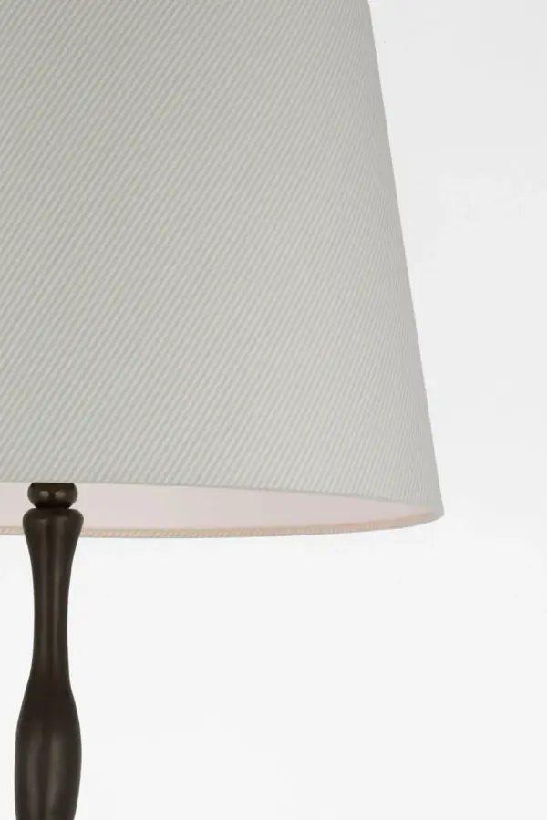 The Romero floor lamp combines traditional bronze metalwork with a distinctive Schumacher blue striped empire shade, creating a sophisticated lighting solution that bridges classic and coastal aesthetics. - alternate view