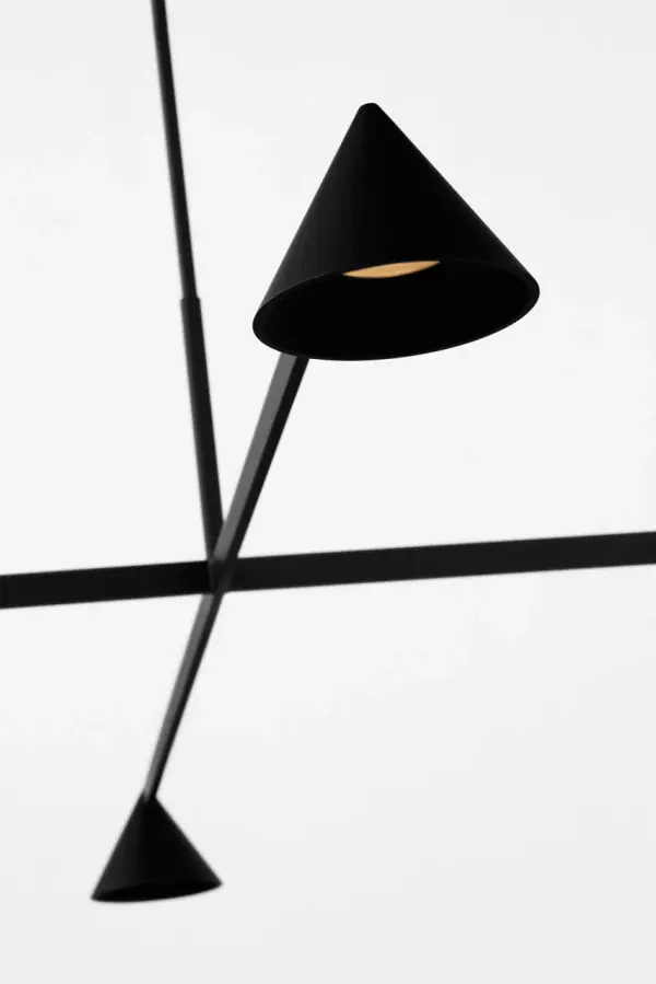 The Midrand 52" Chandelier transforms spaces with its bold, sculptural design inspired by industrial architecture. Multiple tapered metal shades create striking visual rhythm while delivering warm, inviting illumination. - alternate view