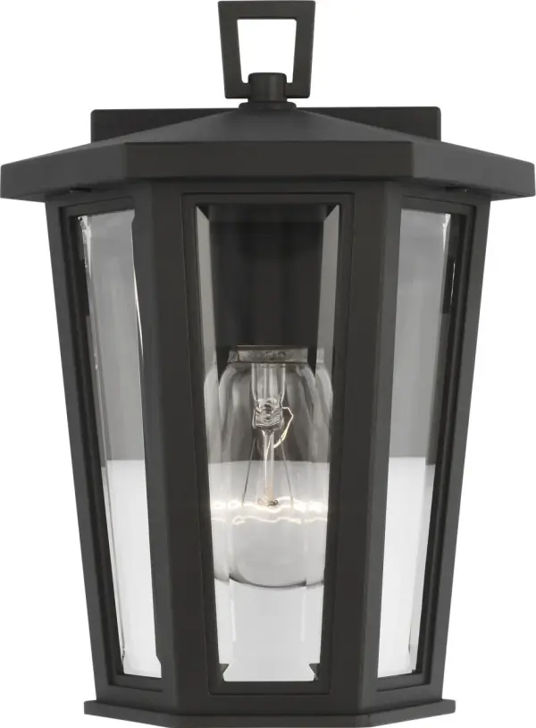 The Witley Mini Wall Lantern combines industrial charm with refined elegance through its faceted clear glass panels and textured black frame. Its geometric, multi-sided design adds depth while the trapezoidal top loop provides a sophisticated finishing touch.